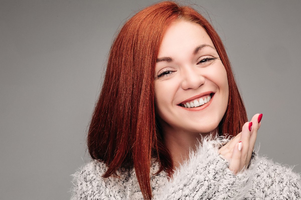 Une femme souriante aux cheveux roux