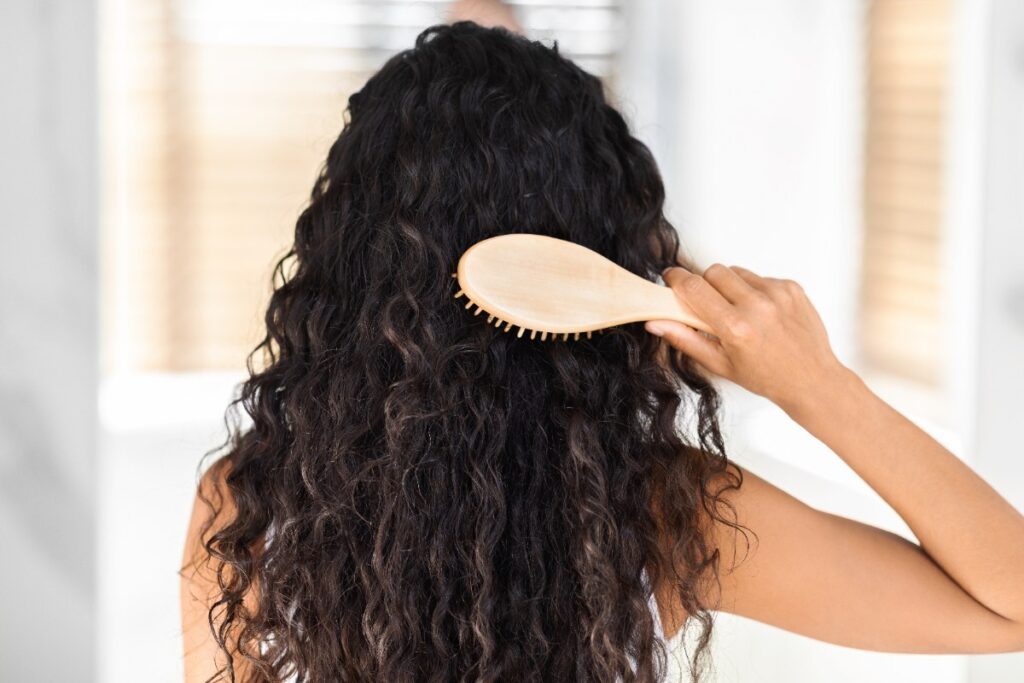 Une jeune femme se coiffant les cheveux